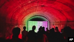 FILE - Rave attendees dance in an abandoned air raid shelter in Guangzhou, China, on Aug. 20, 2023. 