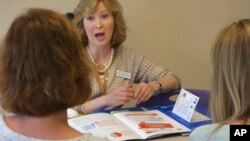 Melissa Jones, center, a nurse educator with Alosa Health, speaks with social worker Jean Easter, left, and physician's assistant Emily Braunegg at a medical office in Monroeville, Pa., May 4, 2017. Jones visits medical offices in western Pennsylvania to educate doctors and their teams about new opioid prescribing guidelines.