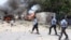 Somali policemen take up position near the scene of a deadly blast in Mogadishu Apr. 14, 2013. 