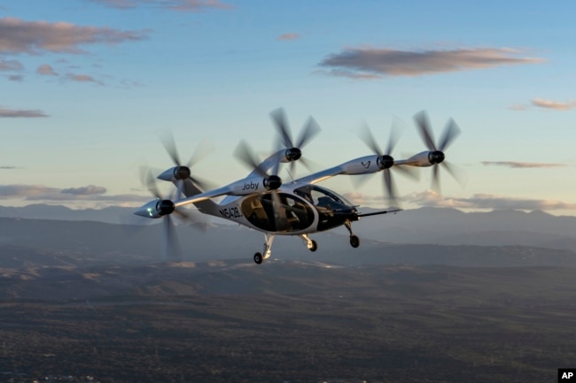 FILE - In this 2022 photo provided by Joby Aviation is Joby’s pre-production prototype aircraft in flight above the company’s facilities in Marina, Calif. (Eric Adams/Joby Aviation via AP)