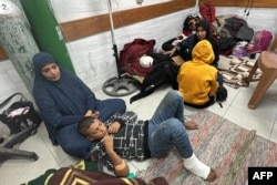 Women and children wait for medical attention as they sit on the floor of the trauma ward in the Kamal Adwan Hospital in Beit Lahia the northern Gaza Strip, Oct. 24, 2024.