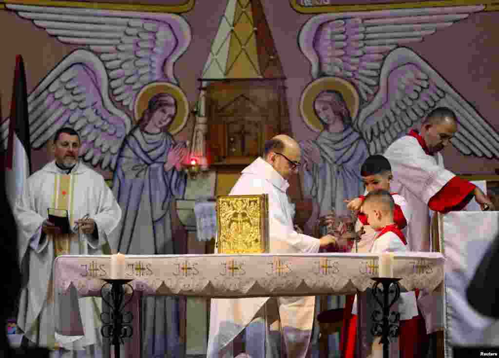 A priest holds a mass on Christmas Eve, amid the Israel-Hamas conflict, at the Holy Family Church in Gaza City, Dec. 24, 2024. 