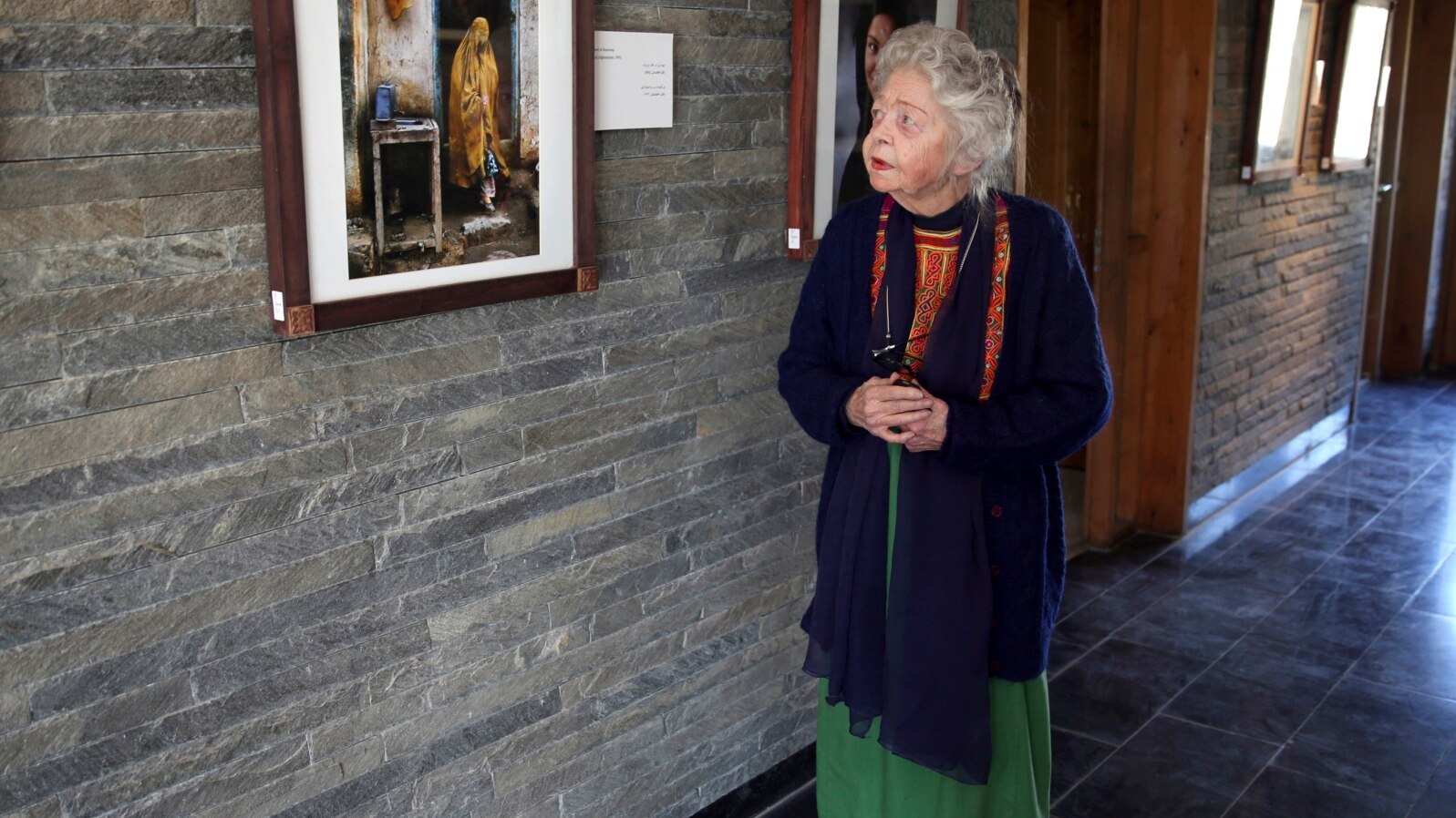 FILE - In this Dec. 9, 2014, photo, American historian Nancy Hatch Dupree talks about a photo taken by National Geographic photographer Steve McCurry during an interview with The Associated Press at the Afghanistan Center at Kabul University. Dupree, who spent decades in Afghanistan working to preserve the heritage of the war-torn country, died this month following a long illness.