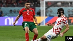 FILES - Morocco's defender Achraf Hakimi (L) fights for the ball with Croatia's defender Josko Gvardiol during the Qatar 2022 World Cup third place play-off football match between Croatia and Morocco at Khalifa International Stadium in Doha on December 17, 2022.