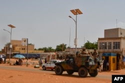 TOPSHOT - A French Army military vehicle belonging to a convoy of French troops is seen crossing the Lazaret district in Niamey on October 10, 2023.