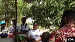 Zero Ebola Campaign volunteers talk to residents in Freetown, Sierra Leone, March 27, 2015. 