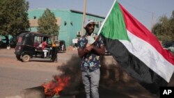 People protests against the October military coup and subsequent deal that reinstated Prime Minister Hamdok in Khartoum, Sudan, Dec. 6, 2021.