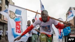 FILE —Supporters of the Audible Actions for Good Governance political group advocating for the re-election of DRC President Felix Tshisekedi at his first campaign rally ahead of the 2023 general elections in Kinshasa on November 19, 2023. 