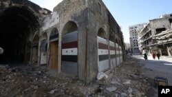 Damaged shops are seen with new doors in the old city of Homs, Syria on Tuesday, Dec. 8, 2015.
