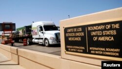 FILE - A truck of the Mexican company Olympics crosses the Puente Internacional Comercio Mundial (World Trade International Bridge) while approaching the border crossing into the U.S., in Laredo.