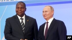 FILE - Russian President Vladimir Putin, right, and President of the Central African Republic Faustin Archange Touadera pose for a photo during a welcome ceremony of the Russia-Africa summit in the Black Sea resort of Sochi, Russia, Oct. 23, 2019.