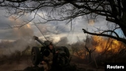 FILE PHOTO: Ukrainian service members fire a howitzer D30 at a front line near the city of Bakhmut