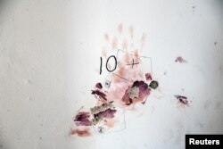 FILE -Blood stains and police forensic details are seen on a wall at a family home in Kibbutz Nir Oz following a deadly infiltration by Hamas gunmen from the Gaza Strip, in Kibbutz Nir Oz in southern Israel October 19, 2023.