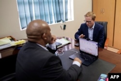 FILE - uMngeni municipality mayor and KwaZulu Natal premier candidate, Chris Pappas (R), speaks with the City Manager at the municipality offices in Howick on January 31, 2024.