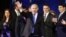 Israel's Prime Minister Benjamin Netanyahu waves to supporters as he stands with his party members at the Likud-Yisrael Beitenu headquarters in Tel Aviv January 23, 2013.