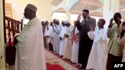 FILE - A photo taken on November 20, 2013 shows Imam Dalil Hayatou (L), leading the prayers at the Great Mosque in Maroua's Dougoi district, northern Cameroon. 