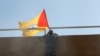 FILE - A flag of Shiite group Sayyid al-Shuhada is placed on the wall of the U.S. Embassy during a protest, in Baghdad, Iraq, Dec. 31, 2019.