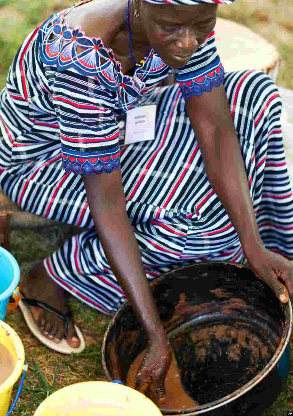 Rukaya Amidu demonstrates the labor of producing shea butter. She is a member of the Christian Mother�s Association shea butter cooperative in Damongo, Ghana.