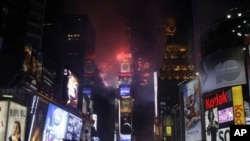 Fireworks erupt from a building to signal the New Year, 2011, in Times Square in New York, 01 Jan 2011