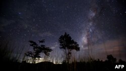 This long-exposure photograph taken on August 12, 2013 shows the Milky Way in the clear night sky near Yangon. The Perseid meteor shower occurs every year in August when the Earth passes through the debris and dust of the Swift-Tuttle comet. 