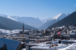 FILE - A Swiss national flag waves in the wind during last year's World Economic Forum, in Davos, Switzerland, Jan. 25, 2019.