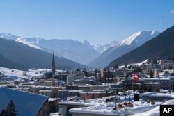 FILE - A Swiss national flag waves in the wind during last year's World Economic Forum, in Davos, Switzerland, Jan. 25, 2019.