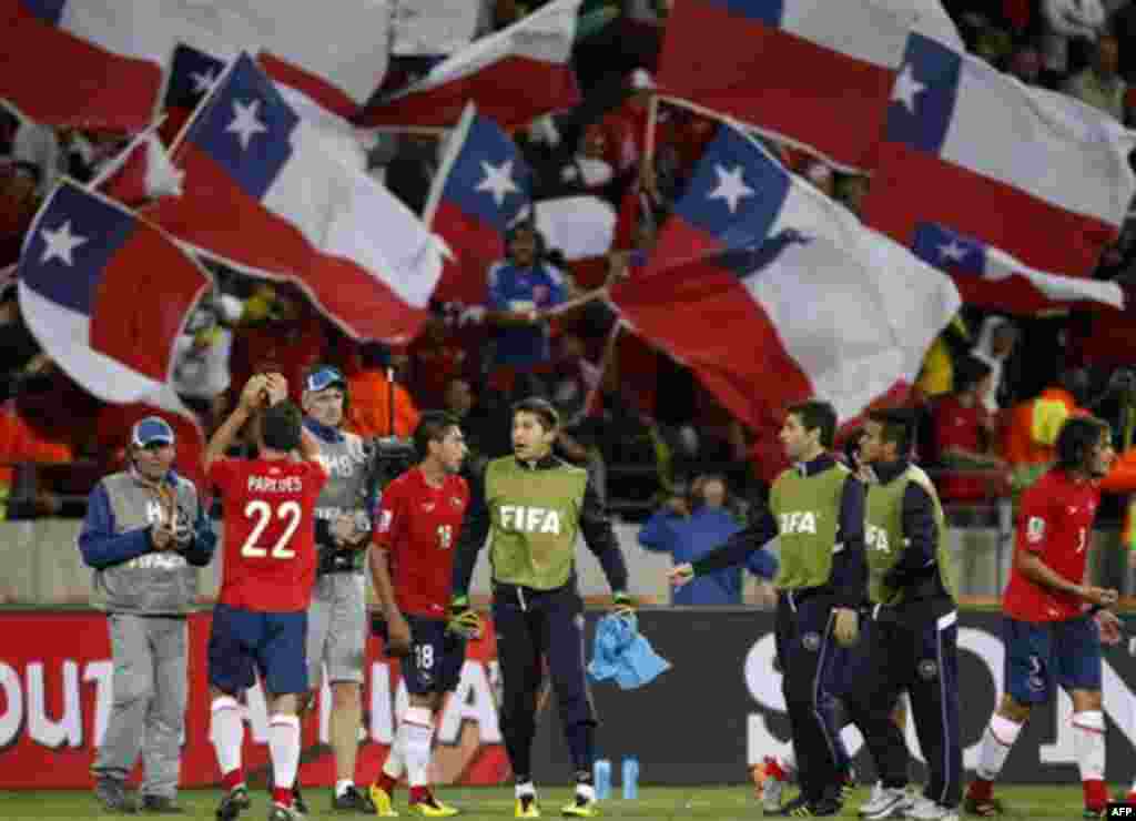 Chilean players, backgrounded by Chilean fans, celebrate after the World Cup group H soccer match between Chile and Switzerland at Nelson Mandela Bay Stadium in Port Elizabeth, South Africa, Monday, June 21, 2010. Chile won 1-0. (AP Photo/Luca Bruno)