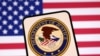 The United States Department of Justice logo and the US flag are seen in this illustration created on April 23, 2025. REUTERS/Dado Ruvic/Illustration/File Photo