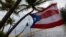 A Puerto Rican flag tied to a swing waves in the wind as Tropical Storm Ernesto approaches Loiza, Puerto Rico, on Aug. 13, 2024.