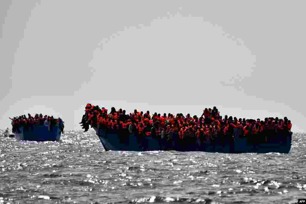 Migrants wait to be rescued as they drift in the Mediterranean Sea some 20 nautical miles north off the coast of Libya.