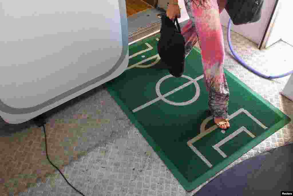 A carpet depicting a soccer field is placed at the exit of an aircraft during the 2014 World Cup, at Belem airport, Brazil, June 15, 2014.