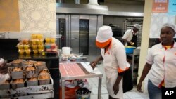 FILE —A employer prepares cake pastries at a bakery Friday, Oct 27, 2023. in Nairobi, Kenya. Kenya, once self-sufficient in sugar, now imports 200,000 metric tons a year from a regional trade bloc.