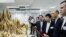 Officials and guests including Hong Kong Secretary for the Environment Wong Kam-sing, second right, are shown seized ivory, May 15, 2014. 