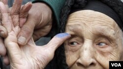 Fadila Mohammed yon granmoun 90 lane kap montre dwèt li apre li finn poze vòt li nan Cairo, madi 29 novanm 2011 la (AP)