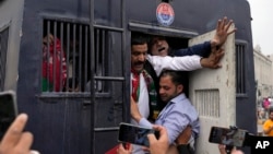 FILE - Security personnel detain supporters of former Prime Minister Imran Khan during a protest against the Pakistan Election Commission, in Lahore, March 10, 2024. Pakistan's National Assembly on June 28, 2024, criticized a U.S. call for an investigation of recent elections.