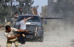 Libyan fighters loyal to the Government of National Accord (GNA) fire their guns during clashes with forces loyal to strongman Khalifa Haftar south of the capital Tripoli's suburb of Ain Zara, April 20, 2019.
