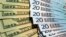FILE - U.S. dollars and euros banknotes are seen in this illustration photo taken at a change bureau in Paris.