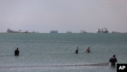 Cargo ships are seen in the Gulf of Suez as Ever Given, a Panama-flagged cargo ship that is wedged across the Suez Canal and blocking traffic, March 28, 2021.