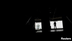 A man walks at a parking garage during a blackout in Caracas, Venezuela, Feb. 6, 2018. 