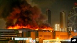 FILE—A massive blaze is seen over the Crocus City Hall on the western edge of Moscow, Russia, March 22, 2024.