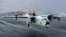 FILE - A C-2A Greyhound logistics aircraft lands on the flight deck of the aircraft carrier USS Harry S. Truman, Sept. 30, 2015.