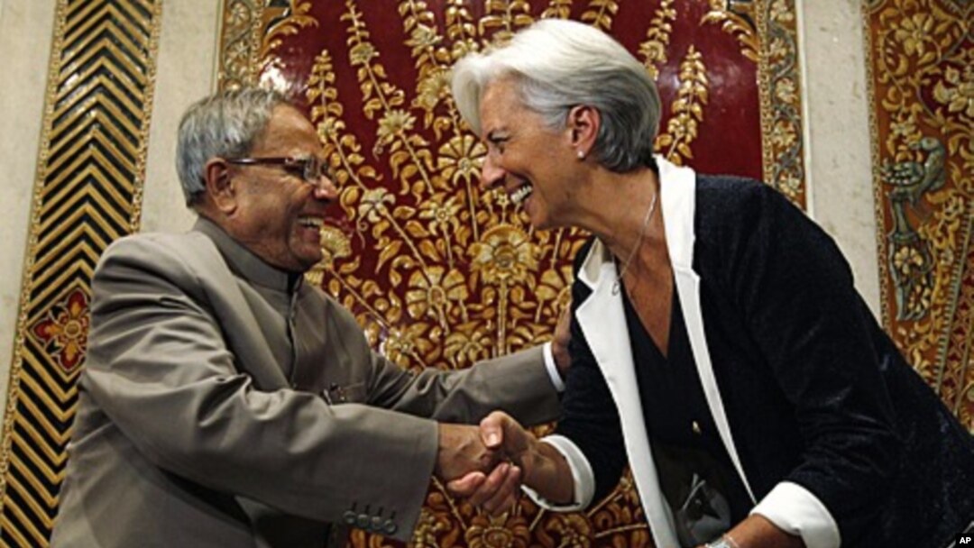 Indian Finance Minister Pranab Mukherjee greets his French counterpart Christine Lagarde in New Delhi, India, Tuesday, June 7, 2011