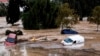 Cars are being swept away by the water, after floods preceded by heavy rains caused the river to overflow its banks in the town of Alora, Malaga, Spain, Oct. 29, 2024. 