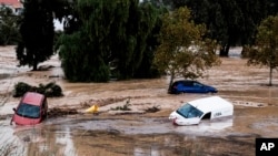 Cars are being swept away by the water, after floods preceded by heavy rains caused the river to overflow its banks in the town of Alora, Malaga, Spain, Oct. 29, 2024. 