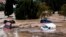 Cars are being swept away by the water, after floods preceded by heavy rains caused the river to overflow its banks in the town of Alora, Malaga, Spain, Oct. 29, 2024. 