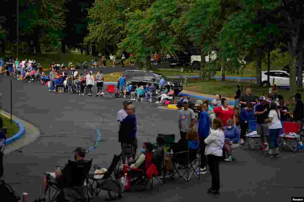 People line up outside Kentucky Career Center prior to its opening to get assistance with their unemployment claims, in Frankfort, Kentucky.