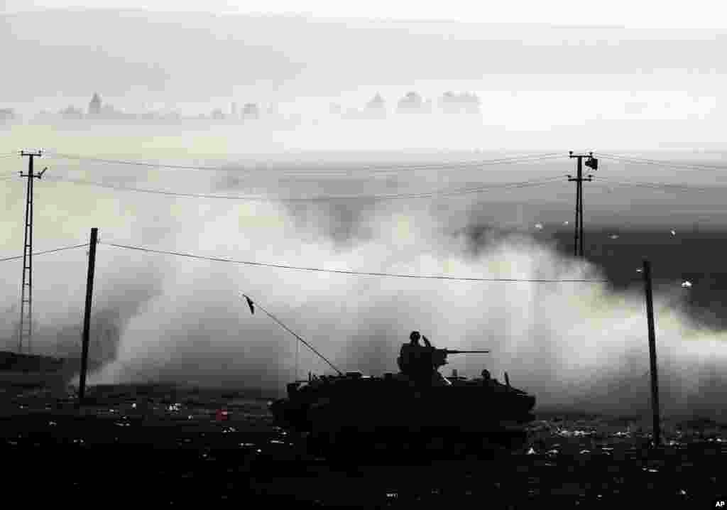 A Turkish armored vehicle patrols the border where fighting between Syrian Kurds and the Islamic State militants&nbsp;has intensified, on the Turkey-Syria border, Oct. 10, 2014. 
