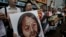 Protesters raise picture of Chinese dissident Tan Zuoren during outside Chinese government&#39;s liaison office, Hong Kong, June 9, 2010.