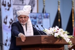 FILE - Afghan President Ashraf Ghani speaks at the Loya Jirga Hall in Kabul, in this handout photograph taken Aug. 7, 2020, and released by the Press Office of President of Afghanistan.