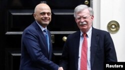Britain's Chancellor of the Exchequer Sajid Javid shakes hands with U.S. National Security Adviser John Bolton at Downing Street in London, Britain, August 13, 2019.